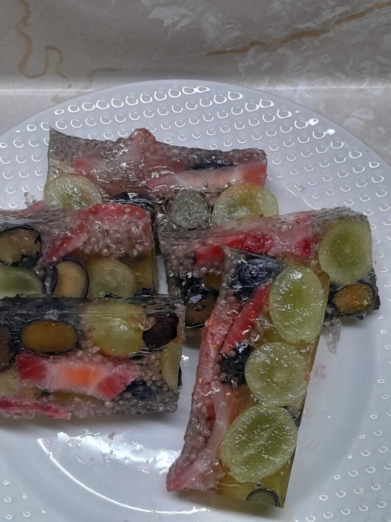 Homemade fruit and chia gelatin bars with strawberries, blueberries, green grapes, and beef gelatin