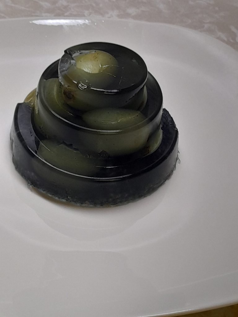 Three-tier collagen gelatin mold made with chia seeds and green grapes